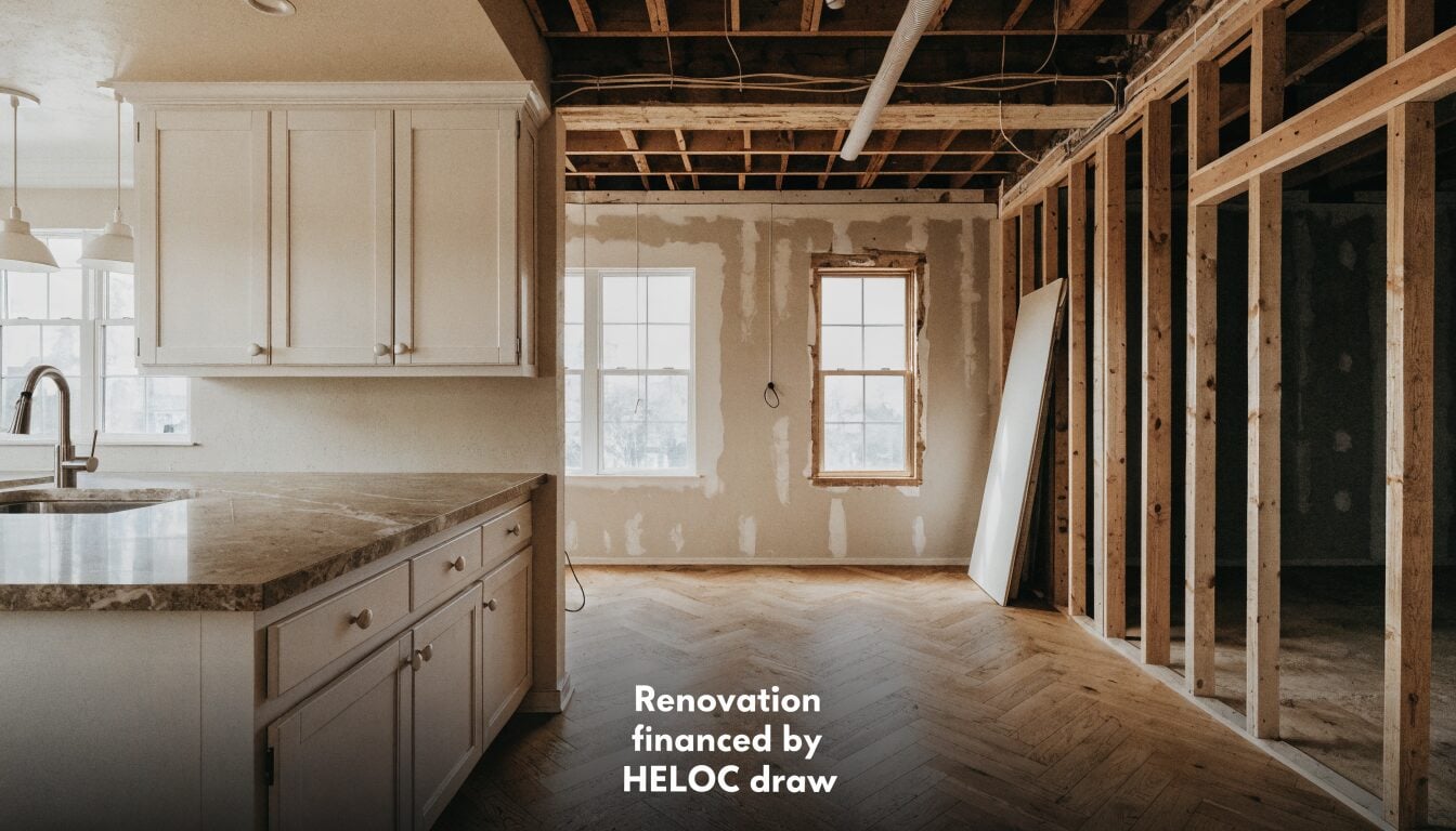 Vancouver kitchen renovation mid-progress, finished cabinetry on one side and exposed framing on the other, showing a phased renovation approach