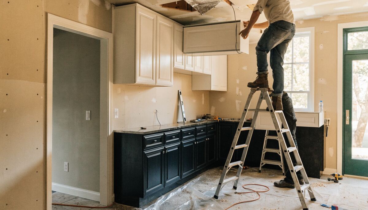 Custom two-tone kitchen cabinet installation in progress in a Vancouver home, dark lower cabinets and white uppers