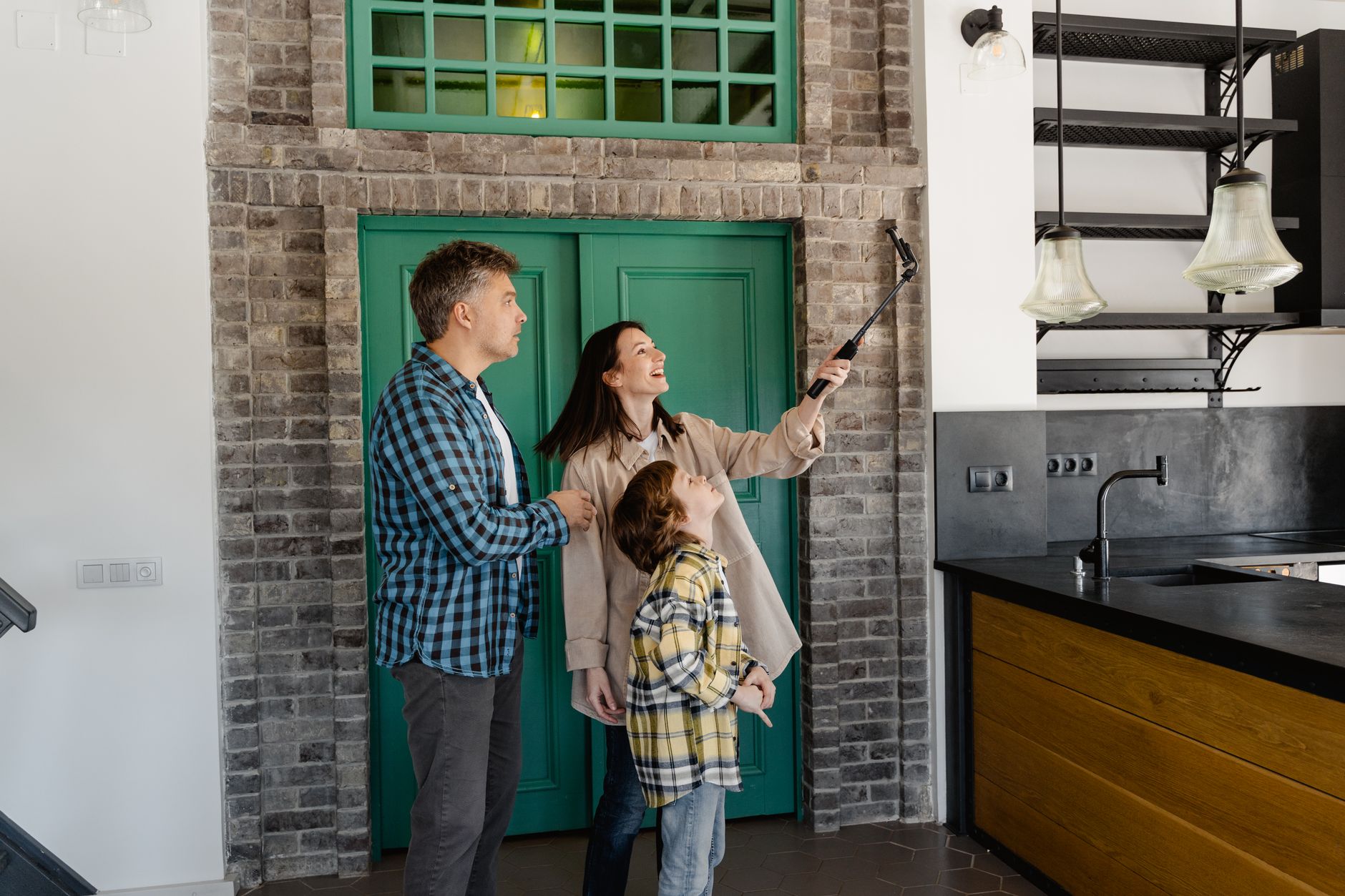 A happy family takes a selfie in their new home, capturing the joy of a new beginning.